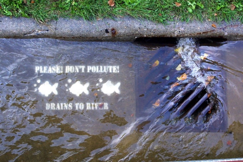 Storm drain showing a please don't pollute message